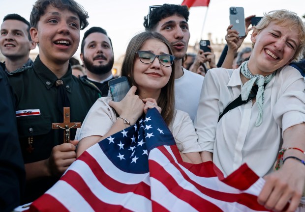 A Polish woman, center, who lives in the United States...