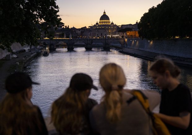 St. Peter's Basilica glows as the sun sets on the Tiber River on May 16, 2025, before the installation of Pope Leo XIV at the Vatican. (Brian Cassella/Chicago Tribune)