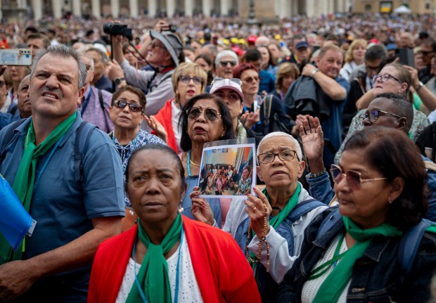 People hold objects to be blessed as Pope Leo XIV holds his first general audience on May 21, 2025, in St. Peter's Square at the Vatican. (Brian Cassella/Chicago Tribune)