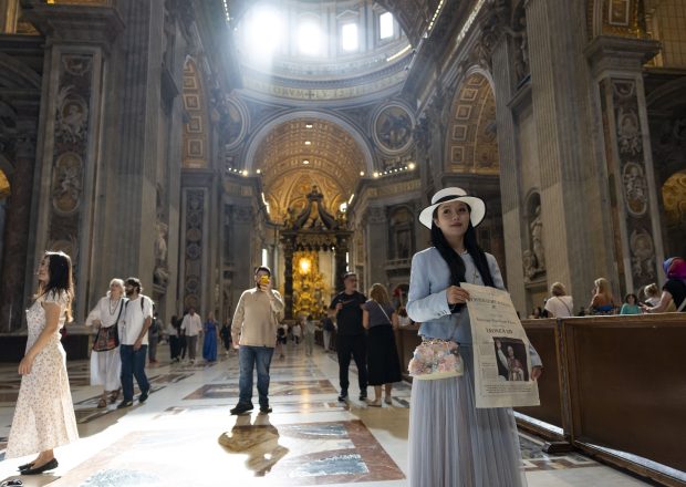 A woman holds a picture of Pope Leo XIV while visiting St. Peter's Basilica on May 15, 2025, before the installation at the Vatican. (Brian Cassella/Chicago Tribune)