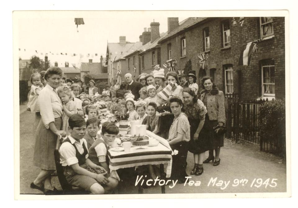 Original WW2 era postcard V.E. day / Victory in Europe Day tea street party celebration, May 9th 1945, parties were held to celebrate the ending of the 2nd World War in Europe. V.E. celebrations. Stanstead Abbotts, East Hertfordshire, England, U.K.