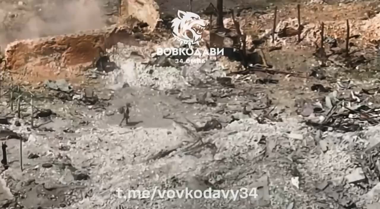 After the Russian soldier is wounded, his comrade grabs his rifle and quickly scrambles back into his hole. Vovchansk, Kharkiv Region