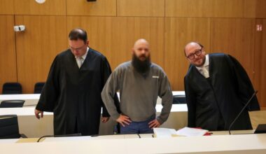Defendant Dieter S, stands between his lawyers Stephan Schultheis (L) and Michael Loewe (R) as he arrives to his trial for spying for Moscow and readying attacks on critical military infrastructure and industry in a court in Munich, southern Germany, on May 20, 2025. Three German-Russian dual nationals will go on trial in Munich on May 20, accused of spying for Moscow and readying attacks on critical military infrastructure and industry. The main suspect, named only as Dieter S, is said to have been at the centre of a plot to undermine Germany