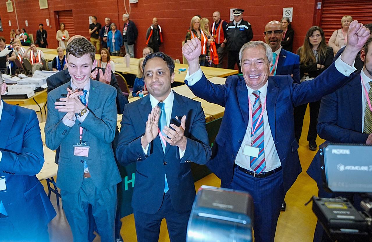 Reform UK leader Nigel Farage (right) and chair Zia Yusuf (centre) celebrate for the media after Reform candidate Sarah Pochin won the Runcorn and Helsby by-election at DCBL Halton Stadium, Widnes, Cheshire. Picture date: Friday May 2, 2025.