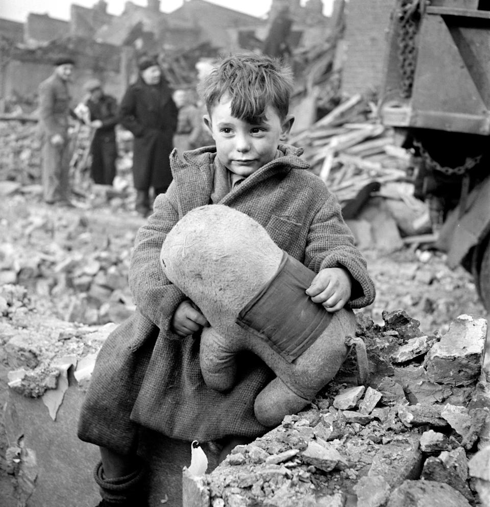 Abandoned Boy holding Stuffed Animal while sitting by Ruins of Building during World War II Bombing of London, England, UK, photograph by Toni Frissell, January 1945
Various