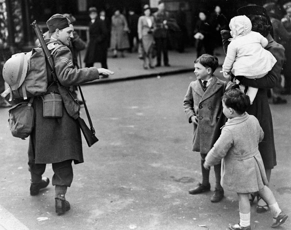 VE Day Celebrations, 8 May 1945. 'An Australian solider leads the victory revellers that include service men and women and civilians'. (Photo by Daily Herald Archive/National Science & Media Museum/SSPL via Getty Images)