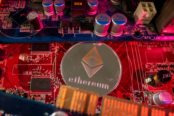 A token representing the cryptocurrency Ethereum placed on a PC motherboard [REUTERS/YONHAP]