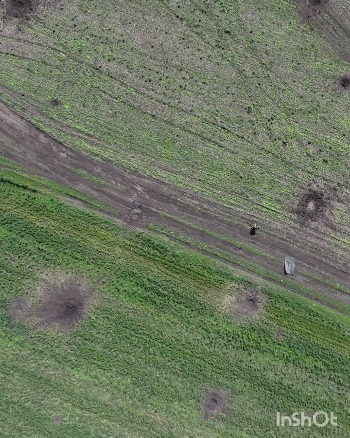 Ukrainian drone munition nicknamed "footcrusher" hits a Russian soldier at long range. May 2025, location unknown