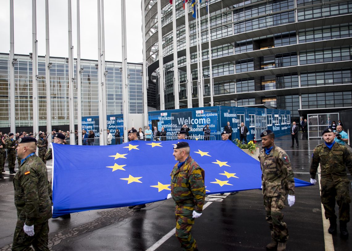 Soldiers of a Eurocorps detachment raise the European Union flag during the open day at the European Parliament in Strasbourg in May 2019.