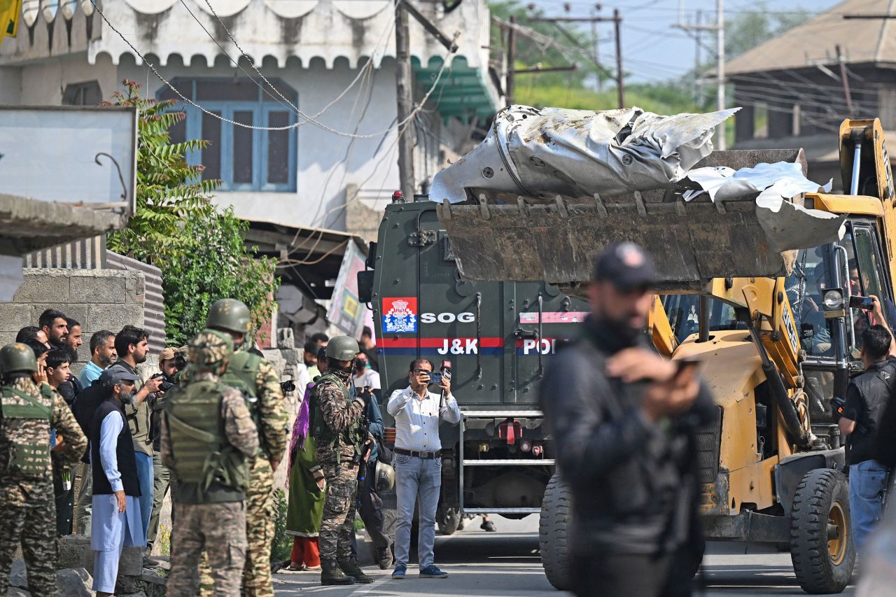 A bulldozer carries the aircraft debris in Wuyan.
