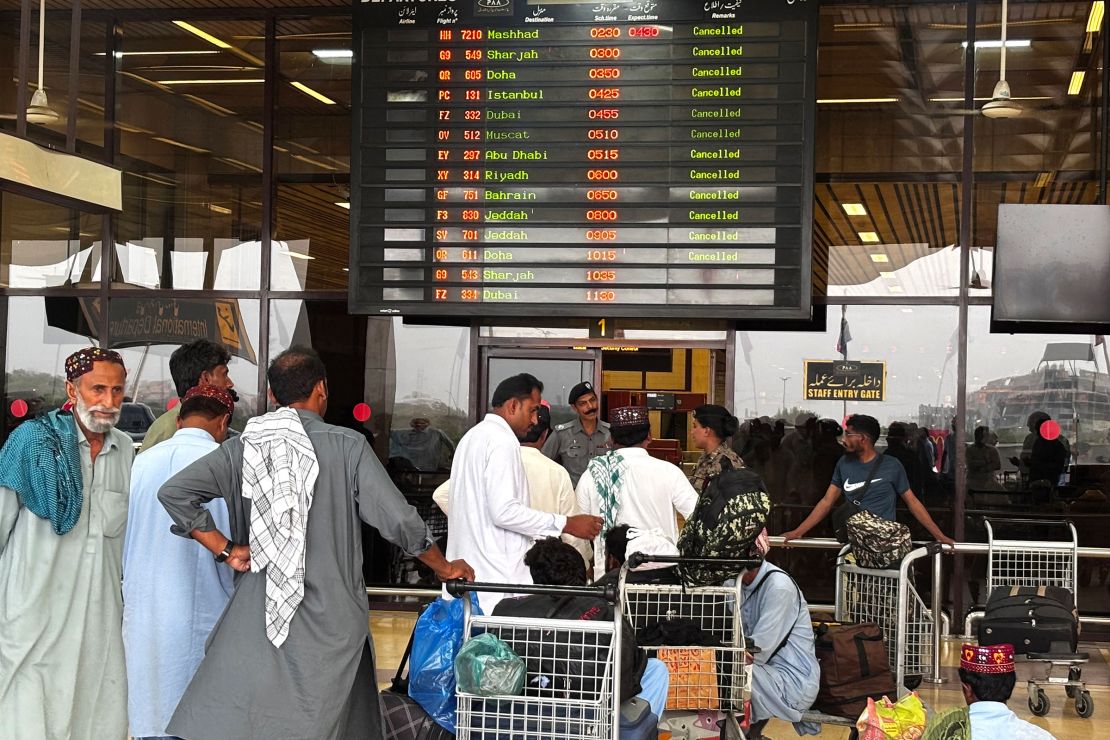 Passengers wait at Jinnah International Airport after all domestic and international flights were cancelled in Karachi on May 7, 2025.