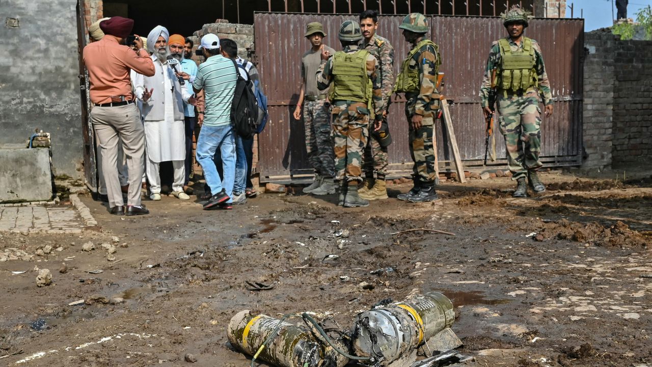 Indian army personnel stand next to explosives, carried by a drone, after it was intercepted by the Indian air defence system, on the outskirts of Amritsar, on May 10, 2025. The Indian army on May 10 reported fresh Pakistani attacks along the border with its arch-foe as the conflict between the nuclear-armed neighbors spiraled.