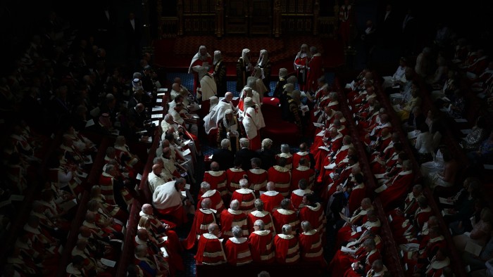 Members of the House of Lords in red and white ceremonial robes gathered for a formal parliamentary event