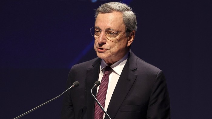 Mario Draghi is speaking at a podium
