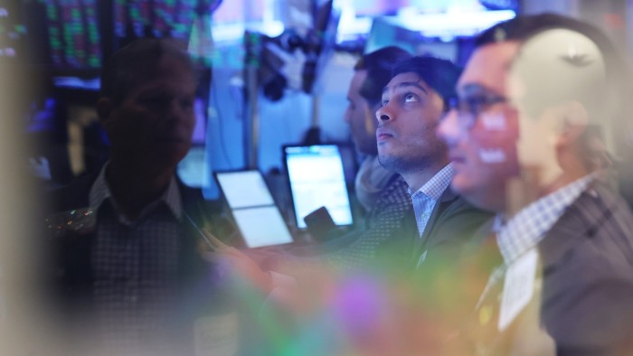Traders work on the floor of the New York Stock Exchange