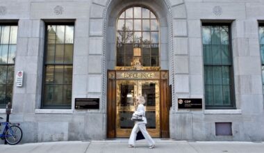 A woman walks by the Caisse de dépôt et placement du Québec building in Quebec city