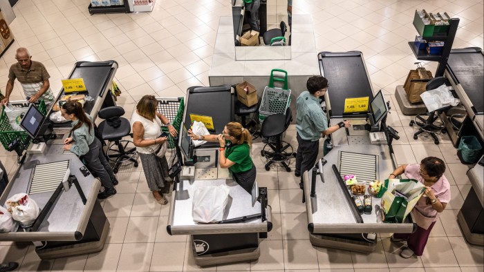 A bird’s-eye view of customers paying for groceries at the checkout counters of a Mercadona SA supermarket