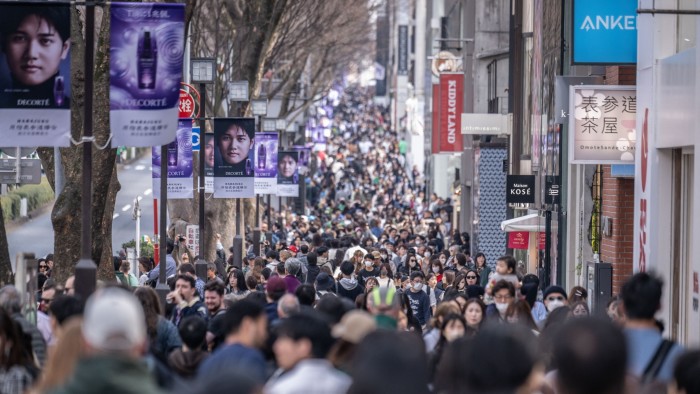 People walk through Omotesando shopping street in Tokyo