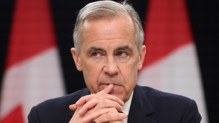 Canada’s Prime Minister Mark Carney listens at a press conference