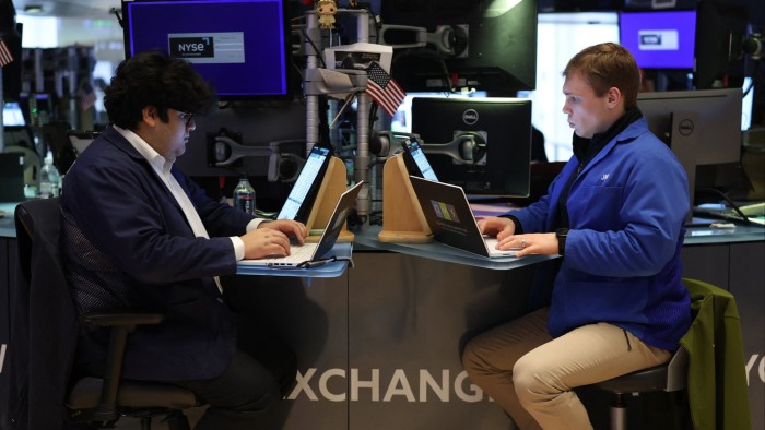 Traders work on the floor of the New York Stock Exchange