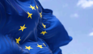 The flag of The European Union flapping in the wind. Economic and finance Community. Politics and Economy. Transnational political government