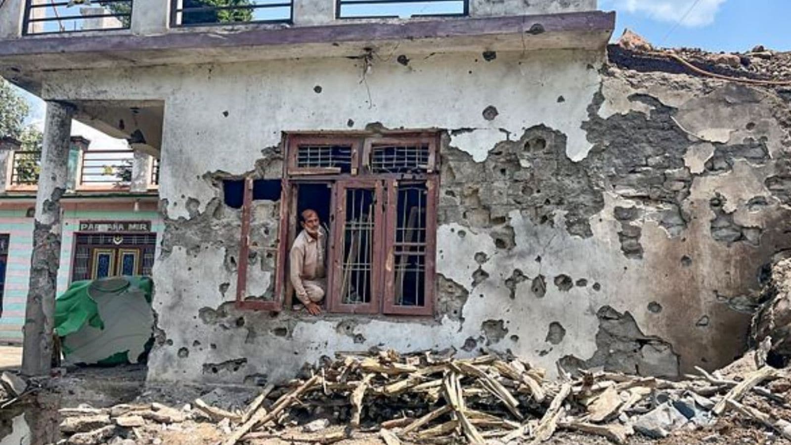 A man stands inside a house damaged after cross border shelling by Pakistan, during the ongoing military conflict between India and Pakistan, at Behra village of Mendhar sector, in Poonch district, Jammu and Kashmir, Saturday