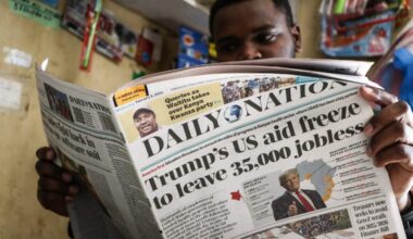 A man in Nakuru, Kenya, reads a newspaper in February 2025 reporting the impact of the U.S. government aid freeze on Kenya and the rest of Africa.