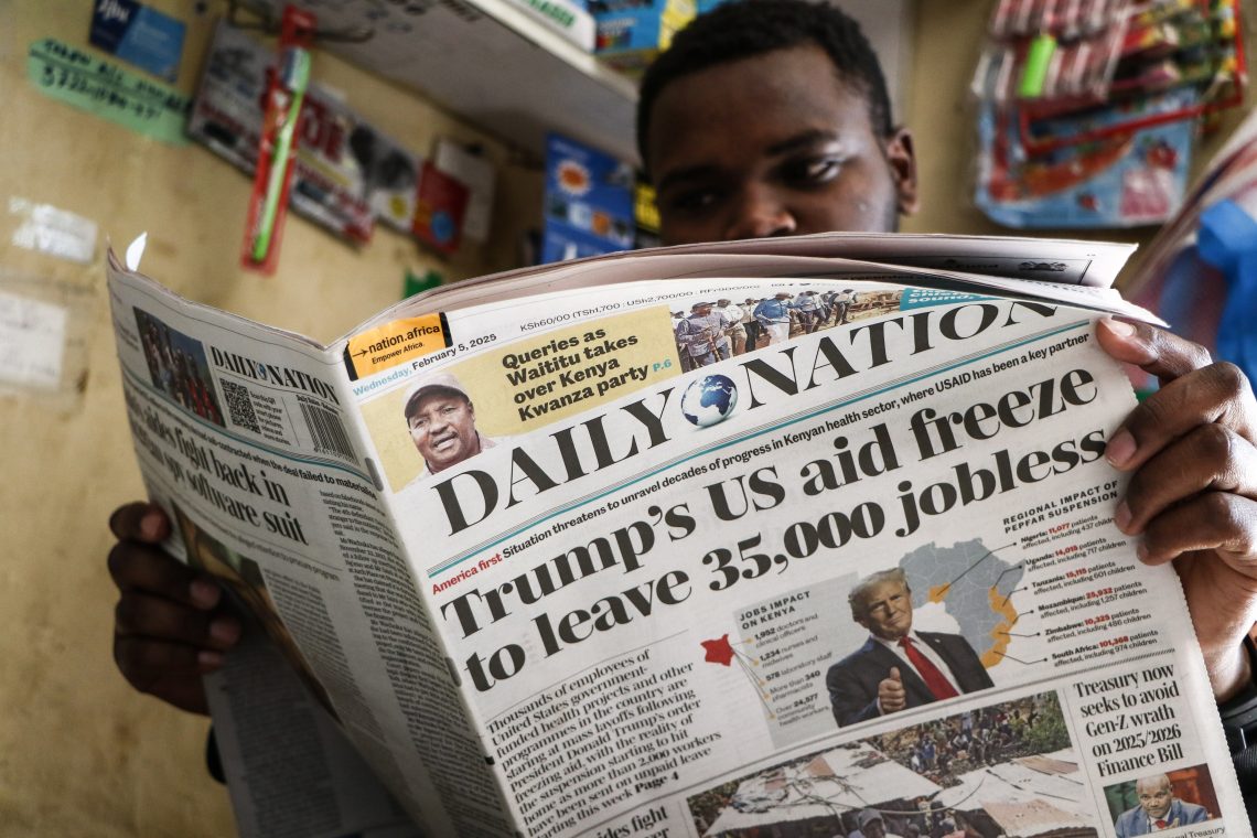 A man in Nakuru, Kenya, reads a newspaper in February 2025 reporting the impact of the U.S. government aid freeze on Kenya and the rest of Africa.