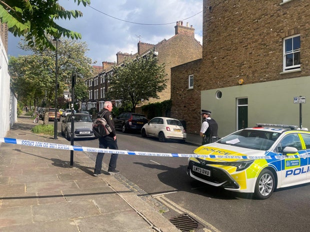 Police survey a cordoned off street, where a fire broke out at Britain's Prime Minister Keir Starmer's home, in north London 