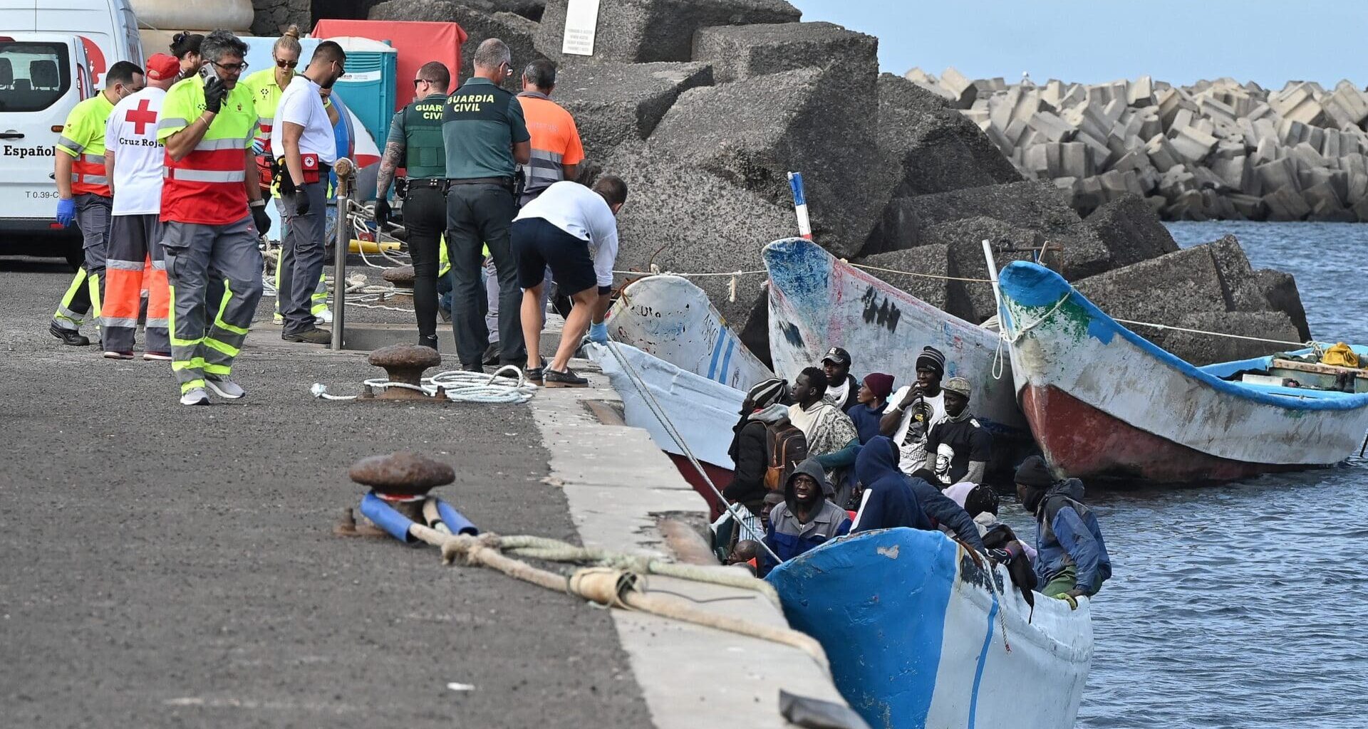 Migrants are helped off a boat by members of the Spanish Red Cross and Guardia Civil officers at La Restinga port in El Hierro, Canary Islands, Spain on 4 February 2023.