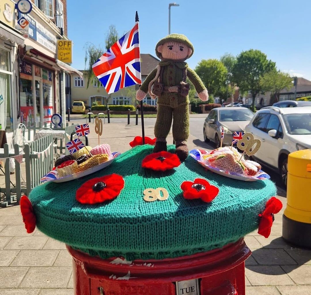 Someone knitted a special VE Day postbox cosy around my local shops