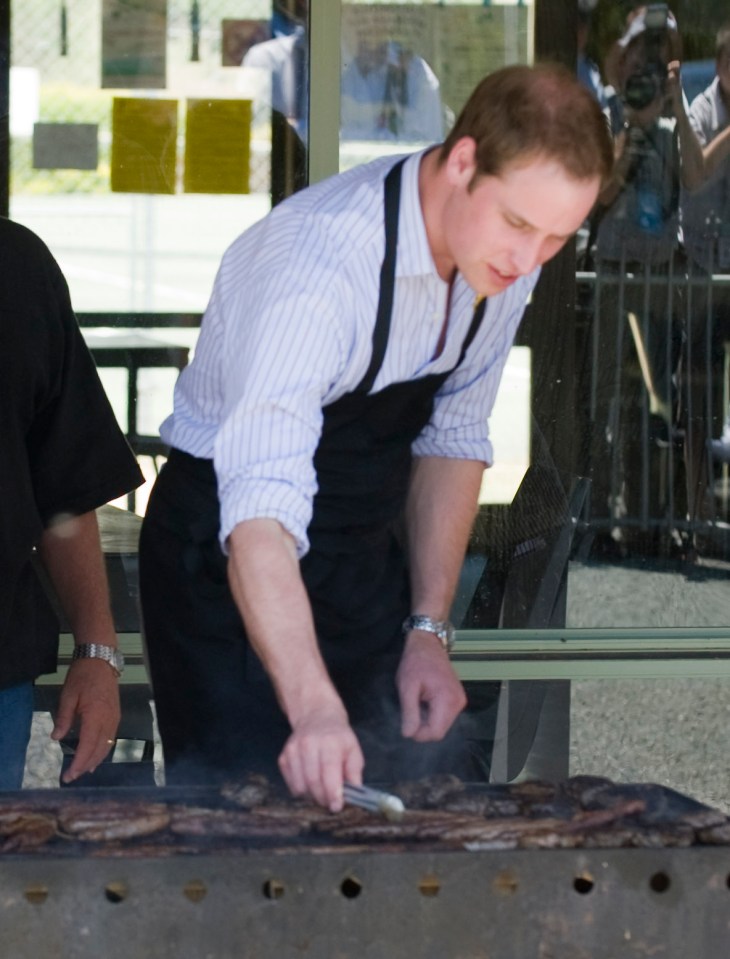 Prince William barbecuing meat.
