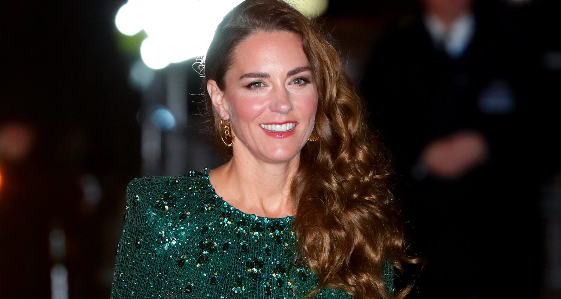 Kate Middleton has long curly brown hair and wears a green sequin gown for the Royal Variety Performance at London's Royal Albert Hall on November 18, 2021