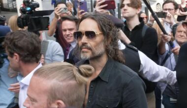 Russell Brand arrives at Westminster Magistrates’ Court after being charged with rape and sexual assault