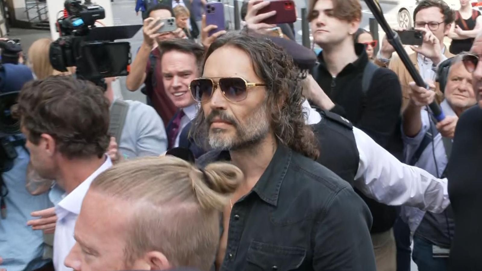 Russell Brand arrives at Westminster Magistrates’ Court after being charged with rape and sexual assault