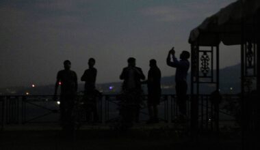 People watching India's air defence system in action during a blackout in Jammu. Pic: Reuters