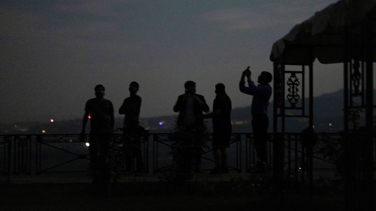 People watching India's air defence system in action during a blackout in Jammu. Pic: Reuters