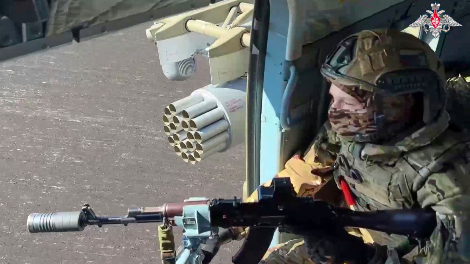 In this photo taken from video distributed by Russian Defense Ministry Press Service on Monday, May 19, 2025, A Russian Army soldier controls an area from a board of military helicopter in an undisclosed location in Ukraine. (Russian Defense Ministry Press Service via AP)