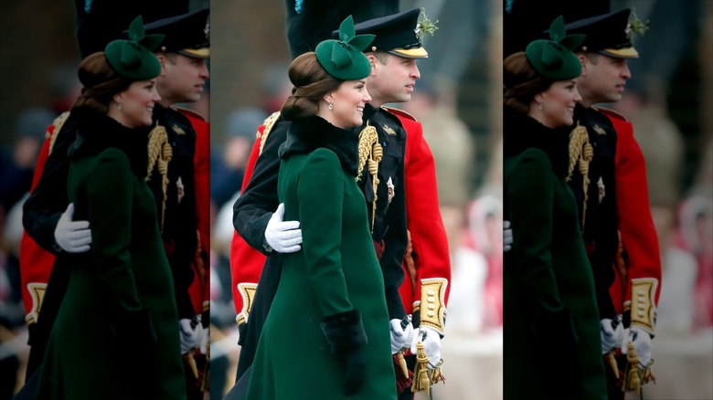 William, Prince of Wales with his arm around Catherine, Princess of Wales