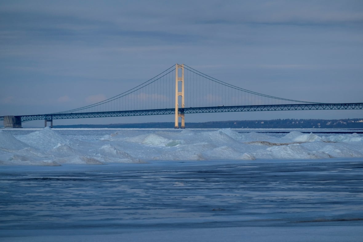 Ice and snow drifts cover the water near the Mackinac Bridge, which spans the Straits of Mackinac between Lakes Michigan and Huron in Mackinaw City, Michigan, U.S. February 25, 2024.  