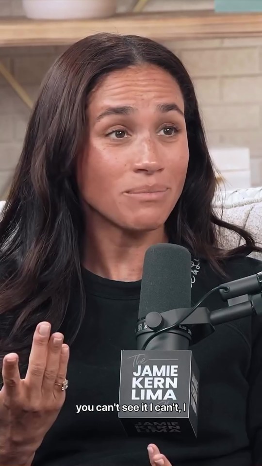Meghan Markle on a podcast, appearing emotional.