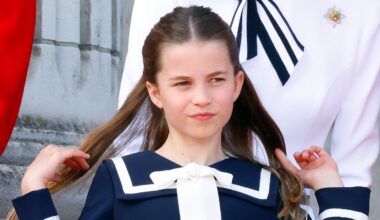 Princess Charlotte flips back her hair as she watches an RAF flypast from the balcony of Buckingham Palace after attending Trooping the Colour on June 15, 2024