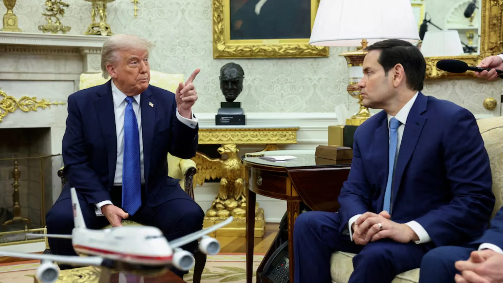 US President Donald Trump gestures as U.S. Secretary of State Marco Rubio looks on, during a meeting with Norway's Prime Minister Jonas Gahr Stoere (not pictured) in the Oval Office of the White House in Washington