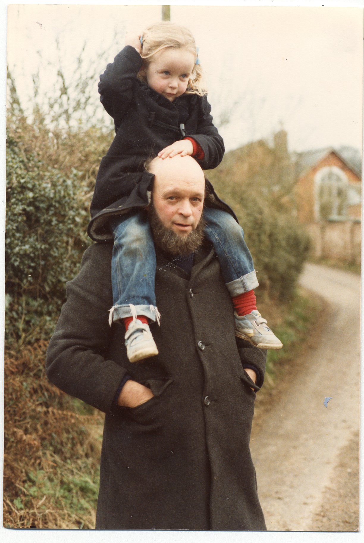 A young Emily Eavis on her father Michael Eavis's shoulders.