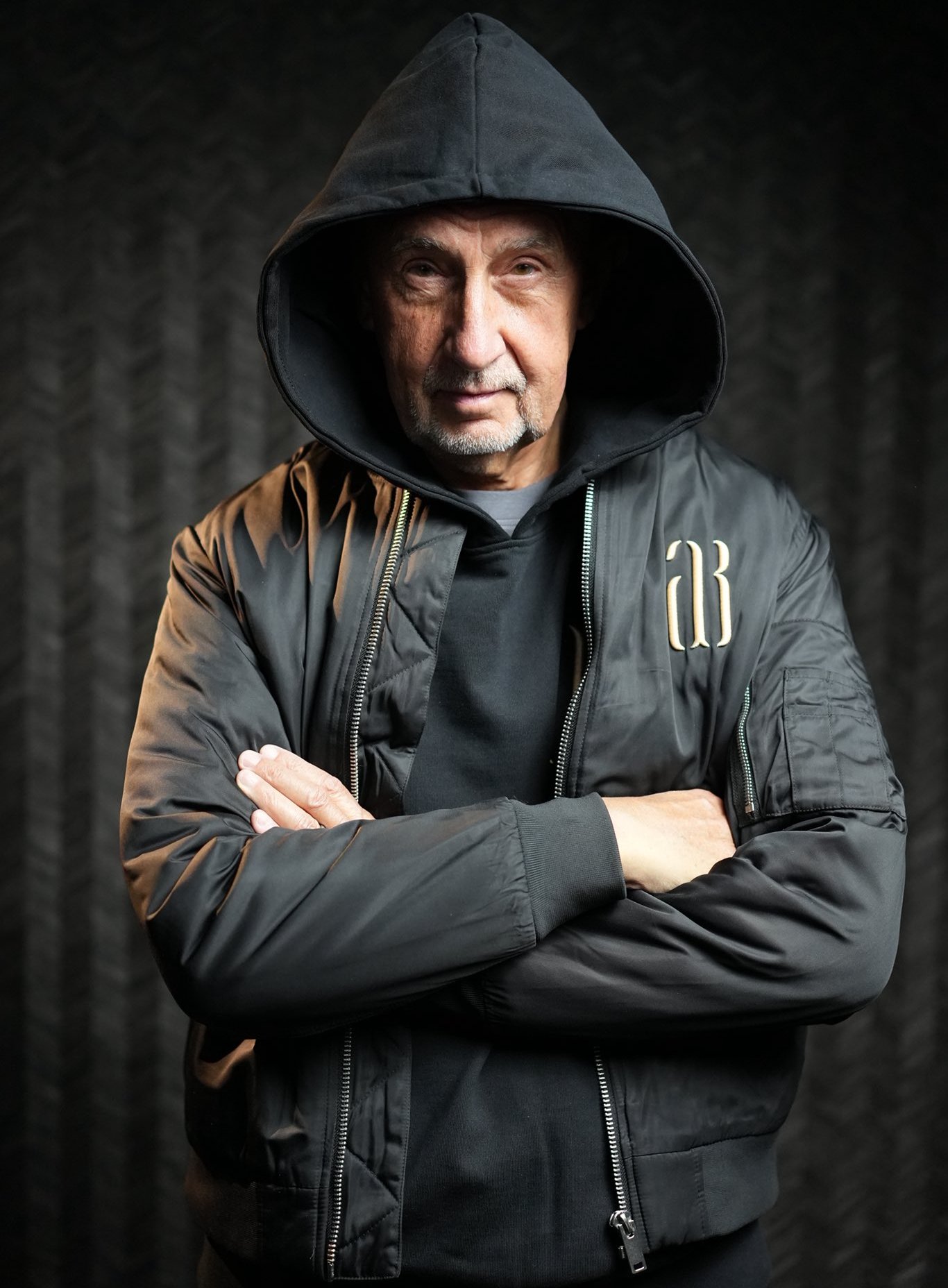 Andrej Babiš wearing a black hoodie and jacket.