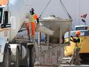 Workers move a load of concrete at the site of an underground parking garage under construction for a 25-storey residential apartment tower at 195 Dundas St. on Friday, April 4, 2025. The London area created 9,500 jobs in the past seven months. 
(Dale Carruthers/The London Free Press)