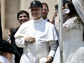 Pope Leo XIV wears a Chicago White Sox hat as he meets newly wedded couples during the weekly general audience in St Peter's Square at the Vatican on June 11.