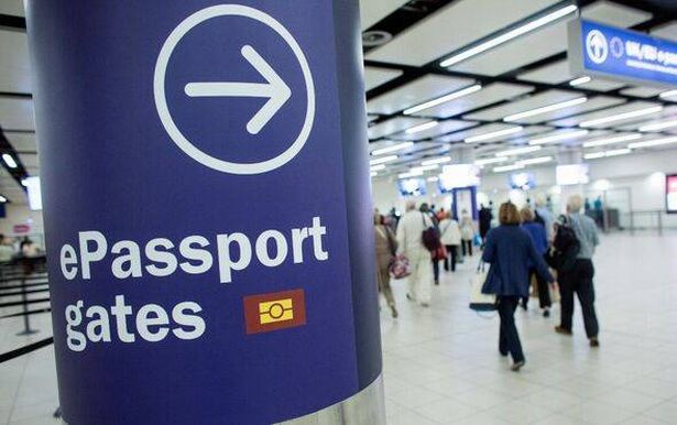 Passengers arriving at Gatwick Airport use the 'ePassport gates' at Passport Control on the UK Border