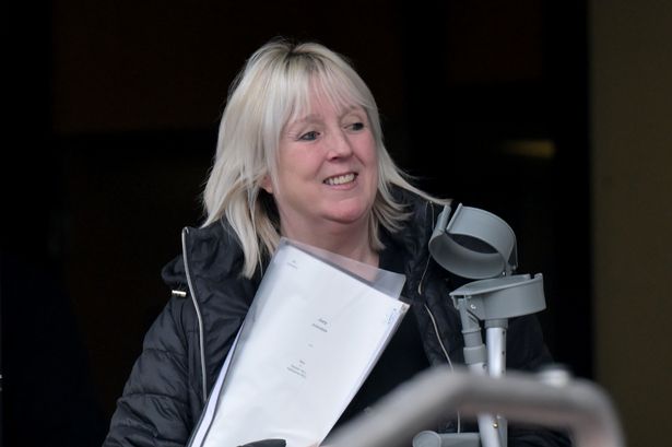 woman holding papers and crutches