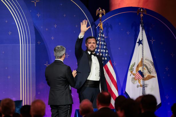 The vice president attempts to cover up his mistake by turning around and waving to the crowd before being escorted off the stage